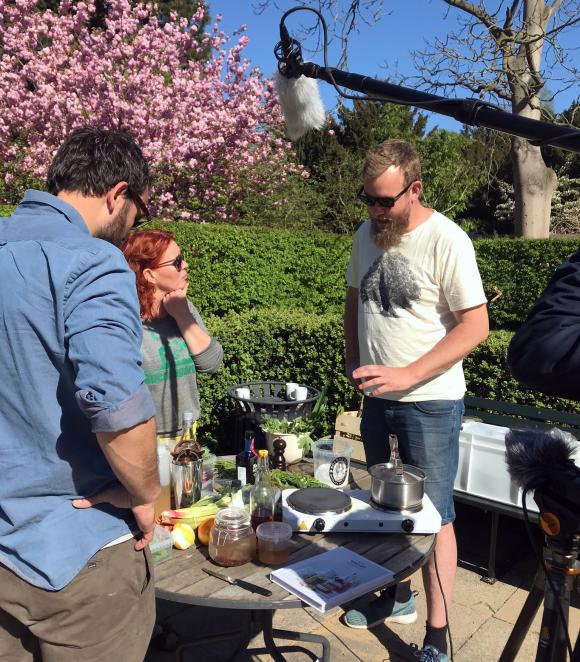 Anja Barfoed fra Haveselskabet har inviteret Jakob Ørstrup til at fortælle om lækre sommersnacks med urter fra haven. Hør mere i podcasten "Spis og drik haven". Til venstre ses Adam Engel.